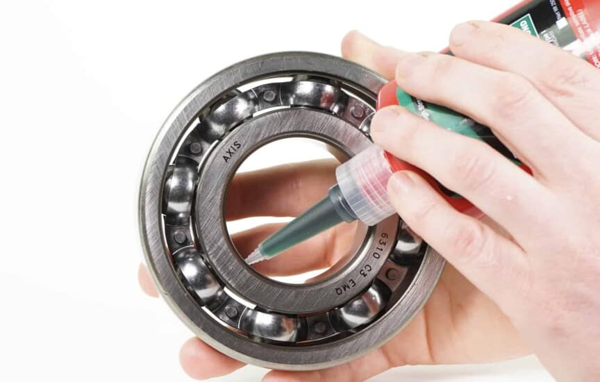 Application of a retaining compound to a bearing's inner ring.